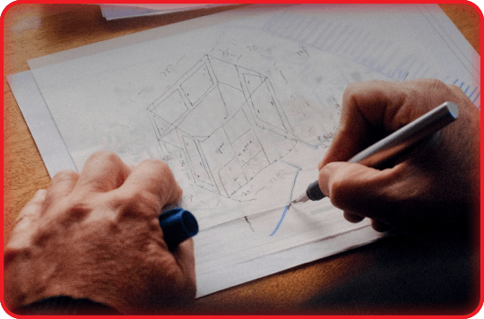 Person evaluating machine safety solution on blueprint