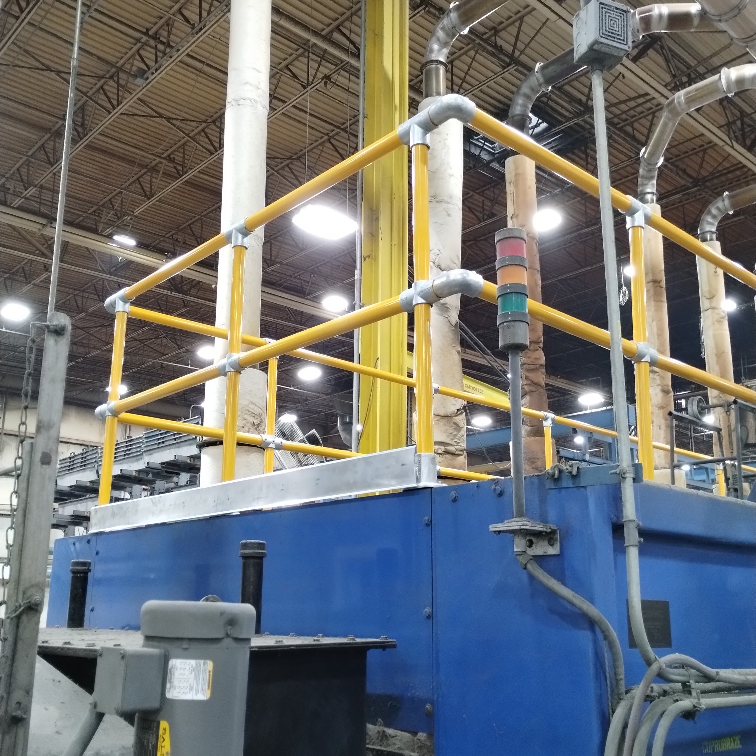 Protective railing for production oven